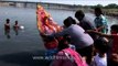 Devotees gathered to immerse statues of elephant-headed Hindu God Ganesha