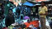 Indian youth buying shoes from Sunday market at Daryaganj