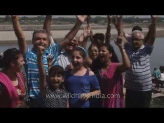 Indian family celebrates Ganpati Visarjan on the ghats of Yamuna River, Delhi