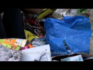 Children helping their mother in recycling activity in Delhi