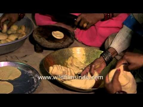 Women kneading wheat dough to make puri