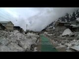 Washed-out houses of Kedarnath covered in snow