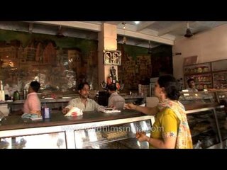Woman buying sweets from a shop in Varanasi