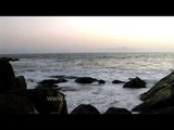 Waves crashing against rocks on a beach, Kerala