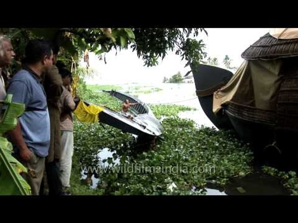 Pulling up a capsized snake boat in the backwaters of Kerala