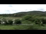 Train journey through lush green fields of Kerala