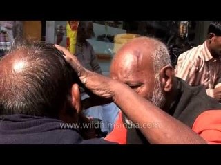 Dentist fixing teeth of his patient on the streets of Varanasi