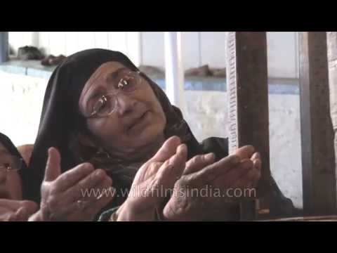 Kashmiri Muslim women devotees pray at shrine of Makhdoom Sahib