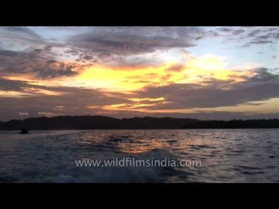 Sunset over the sea with boat cruising