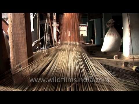 Artisan weaving Banarasi saree in a hand loom factory - Varanasi