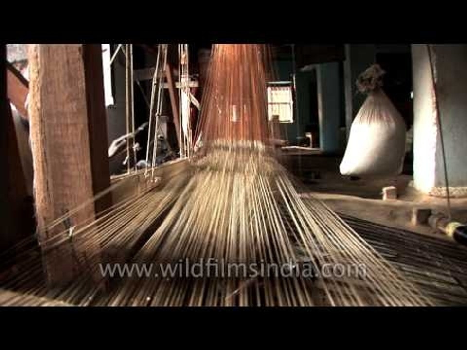 Artisan weaving Banarasi saree in a hand loom factory - Varanasi