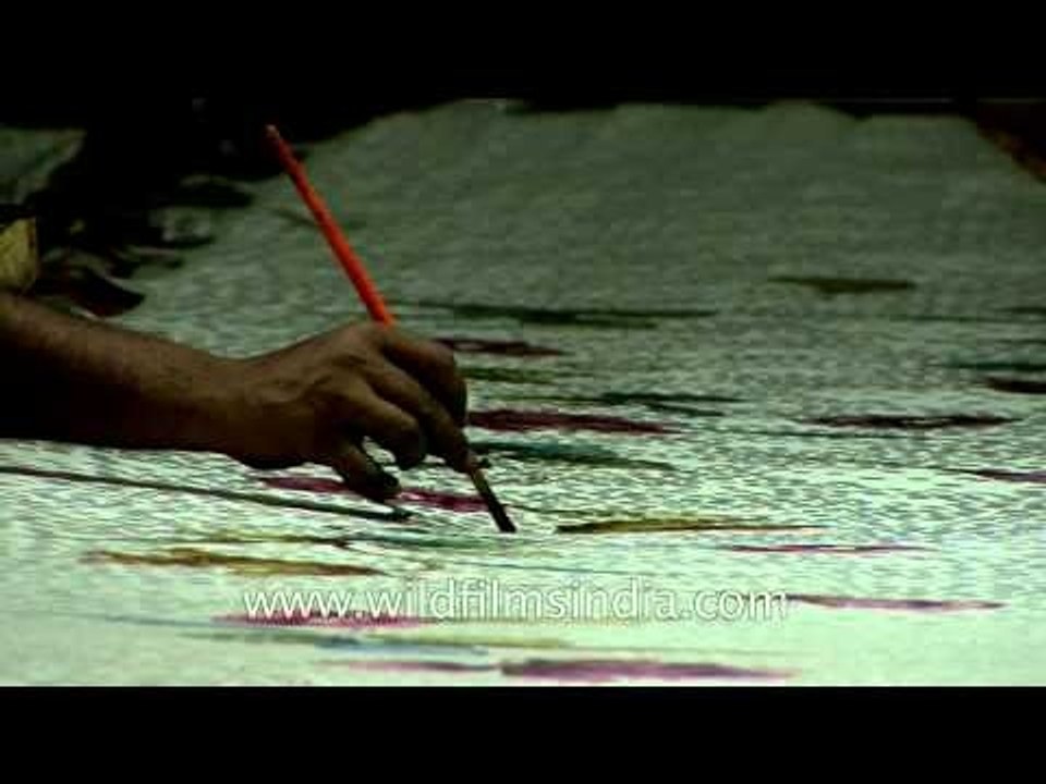 Artisans crafting colorful motifs on Banarasi silk saree