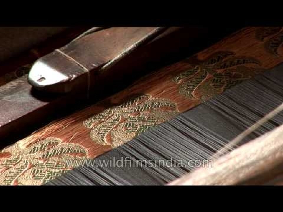 Artisan weaves a Banarasi saree using a traditional weaving machine