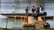 Tourists disembark onto a river jetty in Satpura National Park