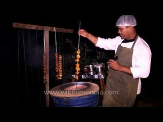 Chef preparing tikkas in an earthen oven