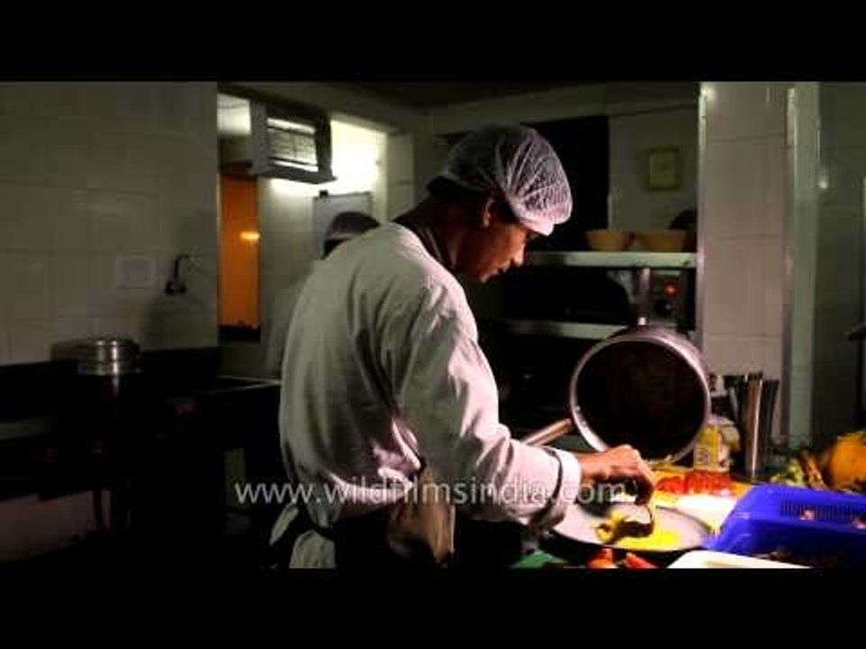 Chef preparing barbeque at a Denwa Backwater Escape lodge