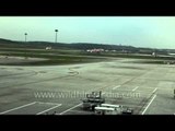Air Asia planes line up on runway of Kuala Lumpur Airport