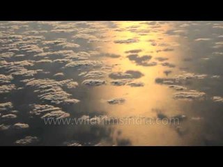 Flying over wispy clouds - Strait of Malacca