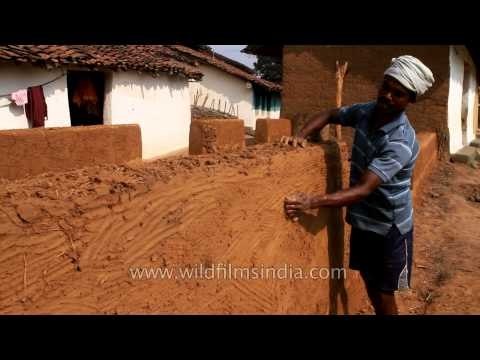 Mud house making at Gond tribal village in Narna, MP