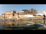 People bathing and washing clothes in the ghats of Varanasi