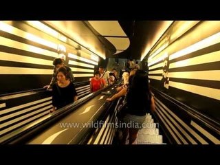 Singapore nationals descend escalator to MRT city underground