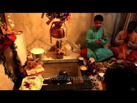Hindu saints perform religious ritual on Shiv Ling