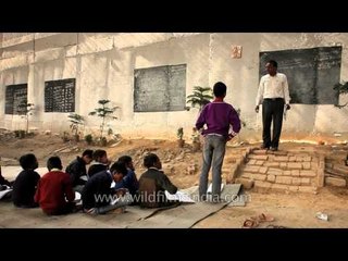 Mr. Rajesh Kumar taking classes under a metro bridge, New Delhi