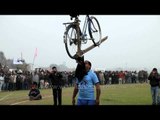 Men lifting plough and cycle with mouth at Kila Raipur