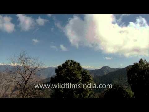 Time lapse of moving clouds above mountain