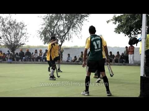 Hockey players passing the ball during the match : Kila Raipur, Ludhiana