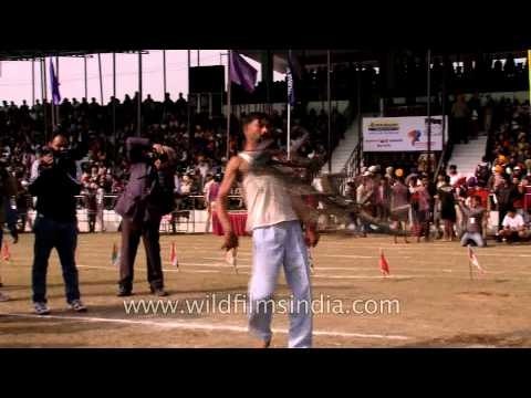 Man spinning cycle with his teeth: Indian Rural Olympic
