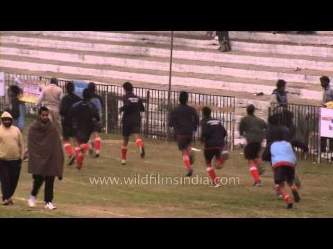 Hockey players warm up during a match at Rural Olympics, Ludhiana