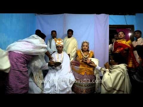 Parents give sweets to Manipuri bride and groom
