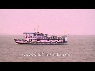 Hindu pilgrims travel on vessels to cross Channel Creek on their way to Gangasagar