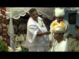 Manipuri bride father performing puja to groom