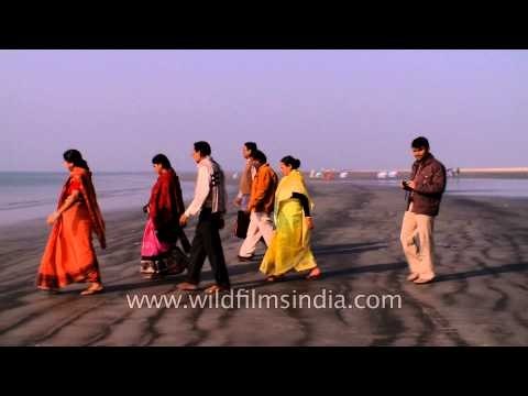 Visitors enjoying the cool sand of Bakkhali Beach, West Bengal
