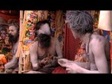 Naga Sadhus sharing smoke pipe during Ganga Sagar Mela