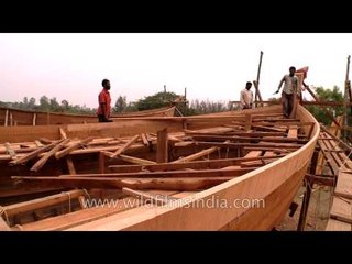 Boat makers assemble the wooden blocks