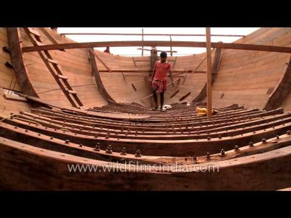 Carpenters working inside a wooden boat in West Bengal