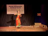 Kuchipudi dancer balancing herself on the rim of a brass plate