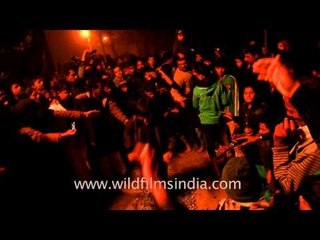 Kids walking barefoot over a bed of hot embers during Chup Tazia