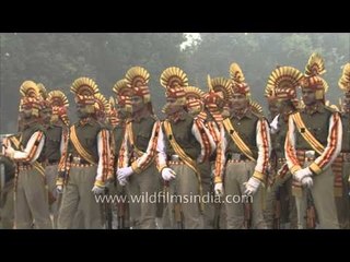 Soldiers in tufted headgear stomp their boots at Rajpath