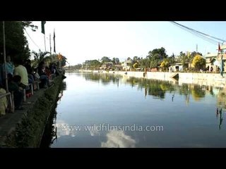 Crowds lining up to watch a boat race, Imphal