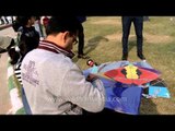 Man tying string to a kite at International Kite festival in Connaught Place, New Delhi