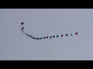 Strings of small kites flying in the sky at Connaught Place