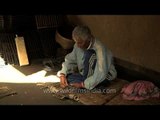 Old man making bamboo fish trap at Loktak Lake