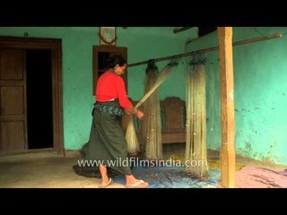 Manipuri woman rearranging fishing nets
