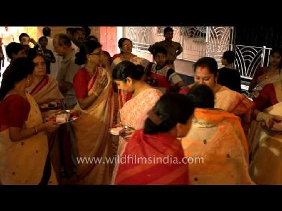 Women applying vermillion on each other's forehead during Durga Puja Festival in Kolkata