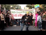 Gay couple poses for photographers at Delhi Queer Pride 2013