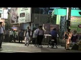 Pedestrians crossing road at zebra crossing in Kolkata city